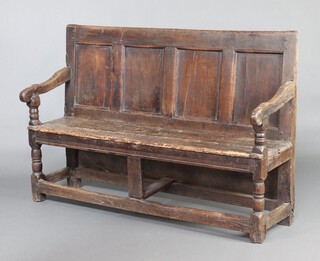 A late 17th Century elm settle with panelled back, raised on turned supports with box framed stretcher 99cm h x 151cm w x 41cm d (seat 130cm x 26cm) 