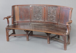 A 17th Century crescent shaped oak settle with solid seat, raised on square supports with H framed stretcher 91cm h x 180cm w x 64cm d (seat 140cm x 50cm)  