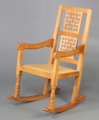 Robert "Mouseman" Thompson of Kilburn, an oak rocking chair with lattice work back, one of the front legs with carved mouse decoration, 99cm h x 51cm w x 70cm d (seat 27cm x 30cm)  