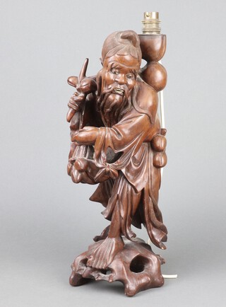 A Chinese carved wooden figure of a standing Deity converted to a table lamp 45cm h