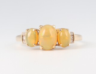 A yellow gold (testing as 9ct) 3 stone opal and diamond ring, 2 grams, size P 1/2