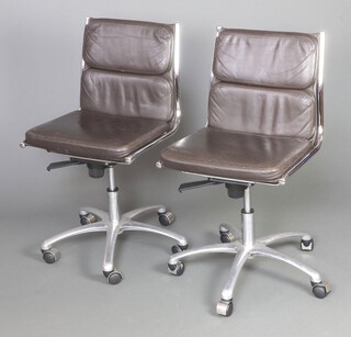 A pair of mid-Century Italian chrome framed and brown leather upholstered revolving office chairs 84cm h x 50cm w x 45cm d 