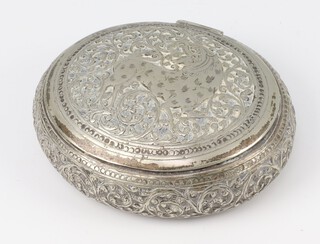 An Indian white metal oval snuff box decorated with a tiger and scrolling flowers, 144 grams 