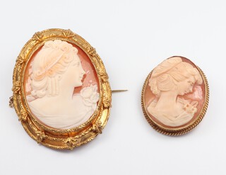 A yellow gold (testing as 9ct) oval cameo brooch and a Victorian gilt ditto 