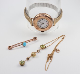 A yellow gold (testing as 9ct) turquoise bar brooch, a peridot and diamond pendant, the 2 diamonds approx. 0.01ct on a ditto chain 36cm and a lady's 9ct yellow gold wristwatch contained in a 20mm case (not working) 