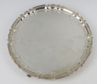 A silver salver with pie crust rim raised on scroll feet  and with presentation inscription, Sheffield 1921, 31cm, 872 grams 