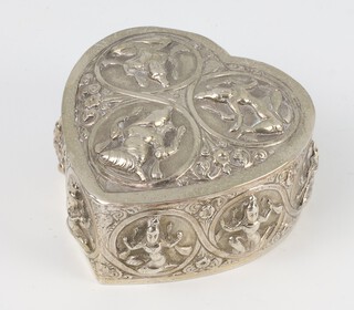 An Indian white metal repousse heart shaped box decorated with panels of deities 8cm, 100 grams 