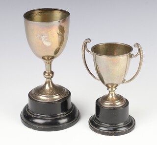 A silver trophy cup Chester 1926, 14cm (dented), a ditto Birmingham 1947 10cm, both on wooden socles 179 grams 