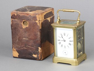 A French striking 8 day carriage alarm clock, the 6cm dial with Roman numerals and alarm dial, contained in a gilt metal case complete with key 12cm x 9cm x 8.5cm, complete with leather carrying case 