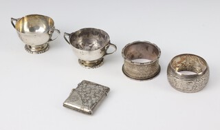 A pair of Edwardian silver miniature trophy cups Birmingham 1904, a vesta, 2 napkin rings, 134 grams 