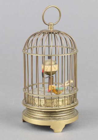 A reproduction Victorian automaton timepiece in the form of a caged bird 3cm x 7cm 