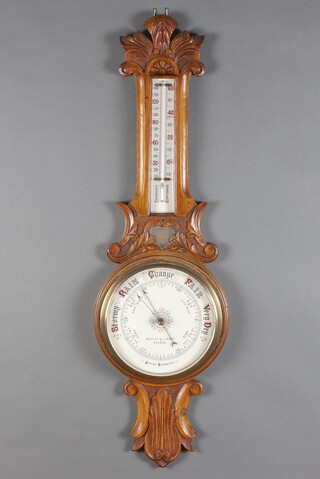 An aneroid barometer and thermometer contained in a carved oak wheel case, the 18cm dial marked Botley and Lewis Reading