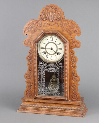 Ansonia Clock Company, an American striking shelf clock with 13cm paper dial, Roman numerals, contained in a carved oak case enclosed by a glazed panelled door 58cm h x 36cm w x 12cm d, complete with pendulum and key