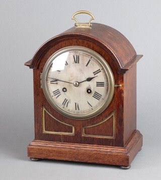 A 1920's striking bracket clock with 14cm silvered dial, Arabic numerals, contained in an oak arch shaped case 30cm x 24cm x 15cm, complete with pendulum and key 