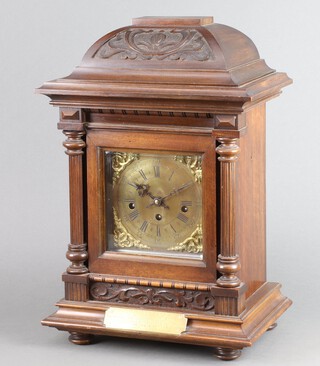 A 20th Century German striking clock, the back plate marked FHS Germany, striking on gongs contained within an Edwardian carved walnut case with 4cm brass dial, Roman numerals and presentation plaque marked presented to EX ACT P.S W Parker by the Officers and Men of Richmond Sub Divn Metropolitan Police as a token of regard on his retirement on pension after 26 years service 4th May 1908 46cm h x 32cm w x 21cm d 