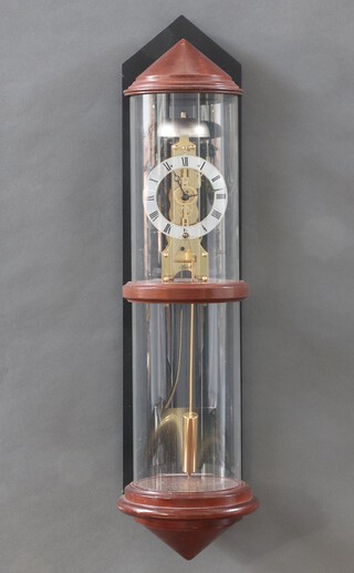 Heinte, a German skeleton clock with 10cm dial, Roman numerals, contained in a wooden and glass cylindrical case 63cm h x 15cm diam. 