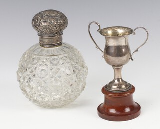 A silver mounted cut glass scent London 1902 11cm (minor chips) together with a miniature trophy cup Birmingham 1902 7cm 