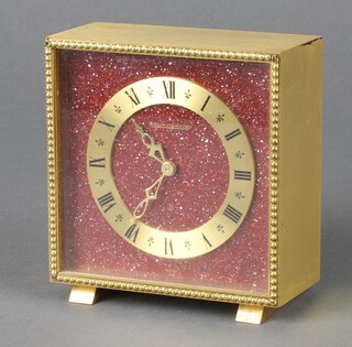 A Jaeger LeCoultre 1950's 8 day timepiece with 10cm granite effect dial, gilt chapter ring, Roman numerals, contained in a gilt metal case 11cm x 11cm x 5cm 