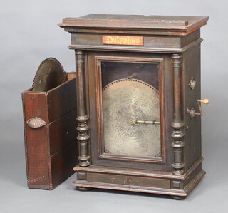 A 19th Century table top/wall mounted polyphon enclosed by a glazed panelled door with columns to the side, the base fitted a drawer, raised on bun feet, contained in a stained pine case 77cm h x 59cm w x 34cm d, together with 36 discs, contained in a wooden carrying case with campaign handles 