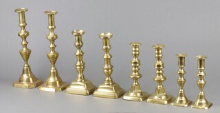 A pair of 19th Century brass candlesticks with ejectors 29cm h and 3 other pairs of 19th Century brass candlesticks (2 loose) 