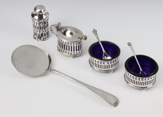 A silver 4 piece condiment with pierced decoration Birmingham 1929, together with a serving spoon 198 grams 