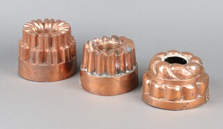 A circular 19th Century copper jelly mould marked BH 10cm x 14cm and 2 other jelly moulds