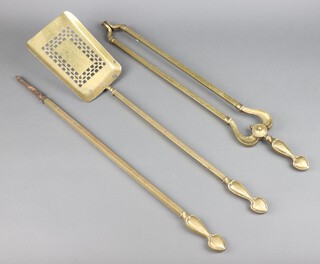 An Art Nouveau gilt metal 3 piece fire side companion comprising shovel, poker and tongs 