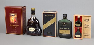 A 70cl bottle of Hennessy Cognac boxed, a 35cl bottle of Remy Martin Cognac boxed and two 30ml bottles of Janneau Grand Armagnac in a wooden box  