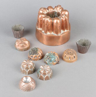 A Victorian copper jelly mould with 5 pointed star mark and no.220 10cm x 14cm, 2 circular waisted jelly moulds 4cm x 4cm no.56 and 7 other jelly moulds 