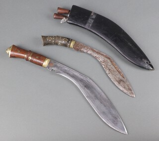 A Kukri with 30cm blade and carved wood handle (light rust to blade), a Kukri with 24cm blade marked Made in India complete with scabbard and skinning knives 