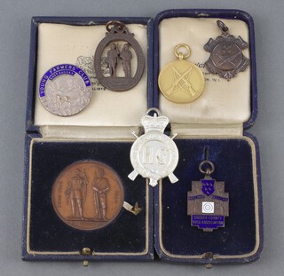 A Home Guard medallion, a Sussex County Rifle Association bronze medallion, 4 other medallions and an East Sussex Young Farmer's Club badge