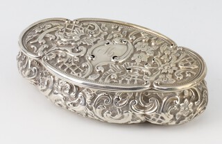 An Edwardian repousse silver quatrefoil box with scroll decoration and engraved monogram Birmingham 1900, 13cm, 95 grams 