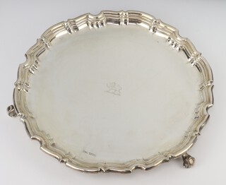 A George V silver salver with pie crust rim on scroll feet with engraved armorial, Sheffield 1911, maker Joseph Rodgers and Sons, 1255 grams, 36cm 