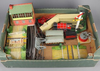 A collection of O-gauge Hornby track and scenery, crossing bridges, crane, station, steps, signalling tower, advertising signs, loco and 2 carriages 