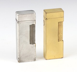 A Dunhill silver plated engine turned cigarette lighter, a gilt ditto 