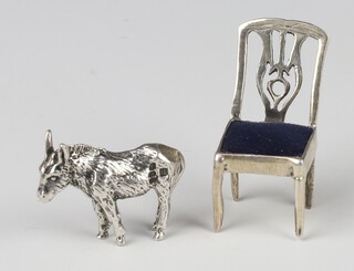 A Continental 925 standard miniature dining chair 3cm and a ditto cast figure of a donkey 2cm 