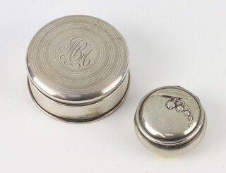 A circular silver pill box with monogram 5cm and a repousse ditto 3cm, 40 grams 