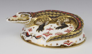 A Royal Crown Derby Imari pattern paperweight  of a crocodile, silver stopper, 17cm 