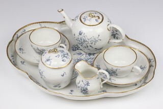 A German 19th Century porcelain breakfast set comprising shaped tray (restored rim), teapot with lid (stuck lid), milk jug, sucrier and lid (stuck finial), 2 tea cups and saucers 