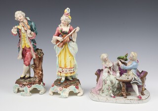 A 20th Century Continental porcelain figure group of a lady and gentleman sitting on a couch 18cm, a pair of 18th Century style musicians on rustic bases 26cm (1 figure is broken) 