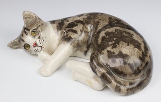 A Jenny Winstanley ceramic figure of a reclining cat with glass eyes no.5, 32cm 