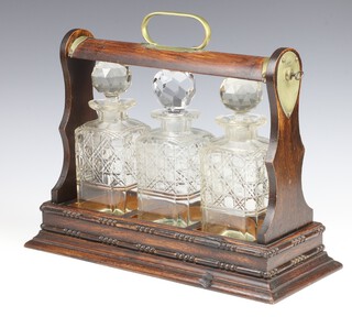 An Edwardian oak tantalus with brass mounts and 3 square spirit decanters and stoppers 40cm 