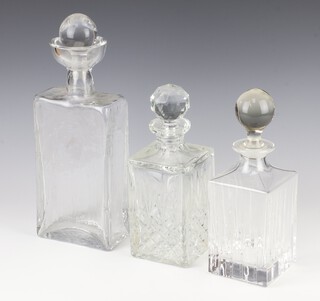 A 1960's rectangular glass decanter with associated stopper 30cm and 2 cut glass spirit decanters and stoppers 