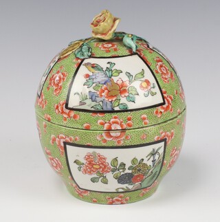 A 19th Century Chinese famille vert circular box and cover decorated with panels of birds and flowers, having a rose finial and 6 character mark to base 17cm 