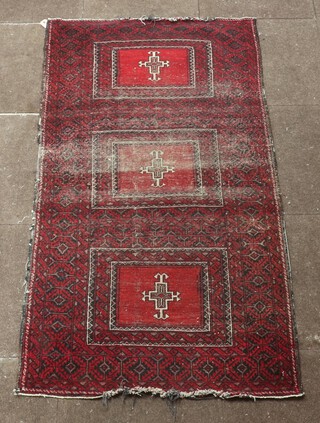 A red, white and black ground Afghan rug with 3 rectangular medallions to the centre 165cm x 89cm 