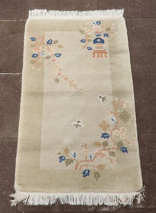 An oatmeal ground Chinese rug decorated butterflies, urn and cover 139cm x 73cm 