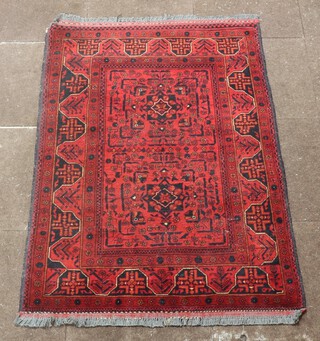 A black and red ground Afghan rug with 2 medallions to the centre 150cm x 101cm 