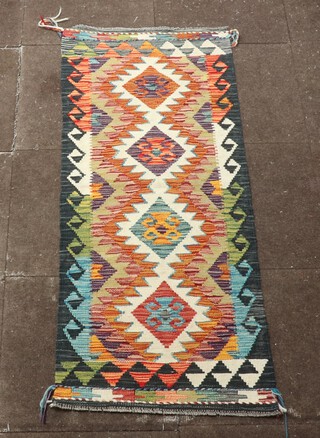 A white, tan and black ground Chobi Kilim runner with 4 diamonds to the centre 153cm x 60cm 