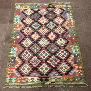 A black, green and purple ground Chobi Kilim rug with all over diamond design 202cm x 127cm 