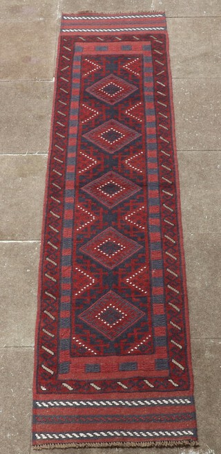 A red and glue ground Meshwani runner with 5 diamonds to the centre 244cm x 56cm 